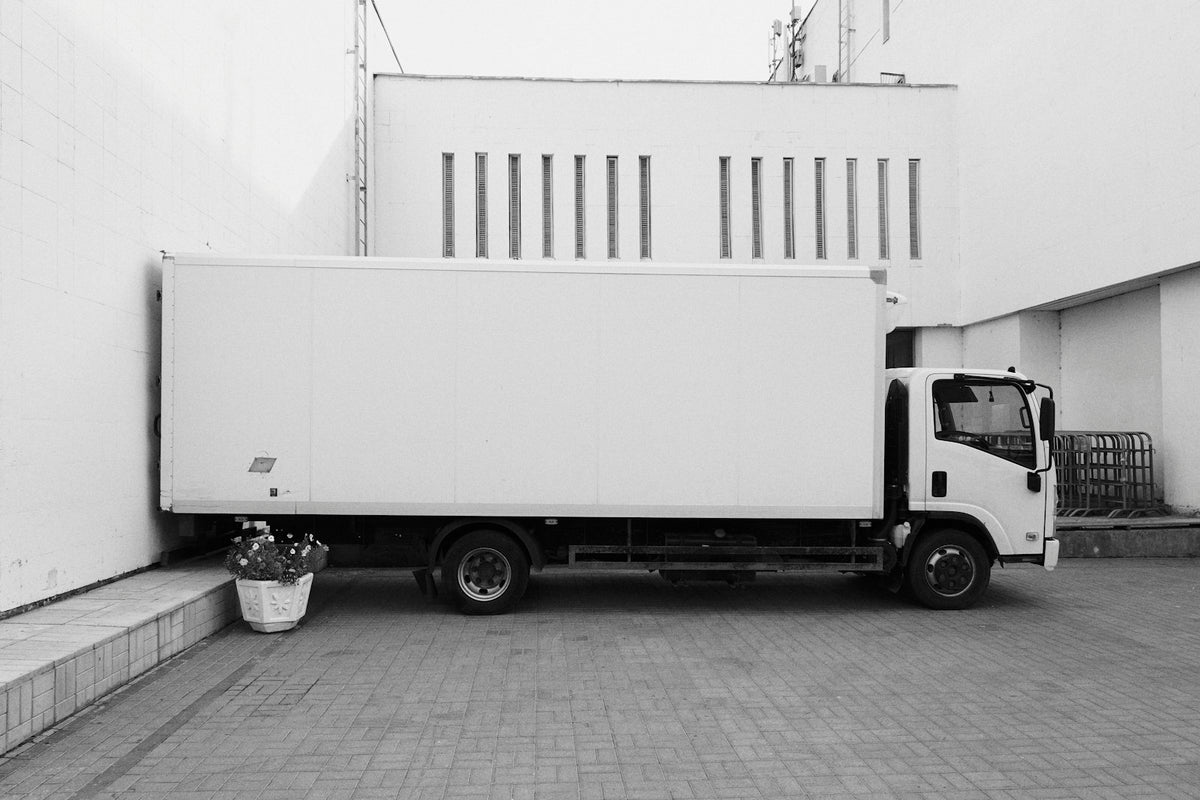 Fleet of delivery vans parked in a row